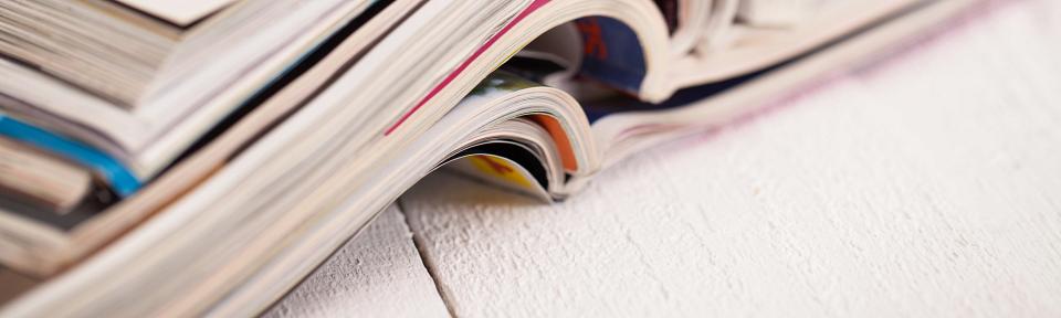 pile of colorful magazines on a table